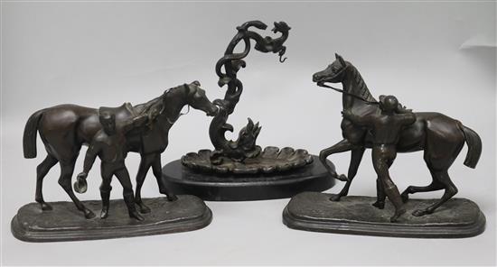 Two spelter jockeys and horses and a spelter watch holder